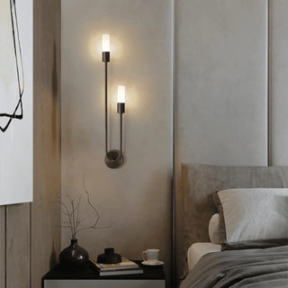 Gold tubular wall sconce installed in modern corridor