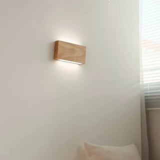 Rectangular wood sconce installed – warm 3000K natural material light