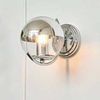 Glass globe wall sconce installed view modern interior