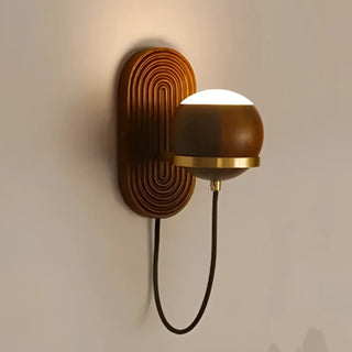 Sadiom walnut LED sconce installed on wall – warm light