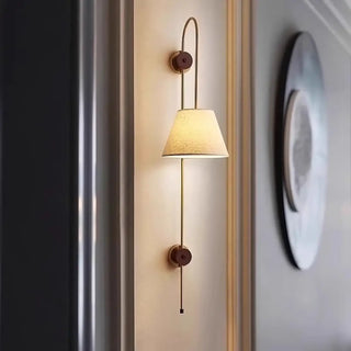 Brass fabric wall sconce dimmable installed warm view