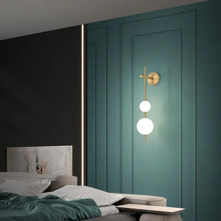 Gold globe wall sconce installed view stairwell