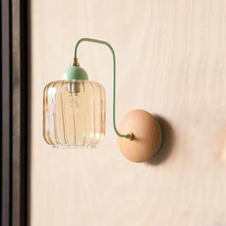 Green glass wood wall sconce installed in modern living room
