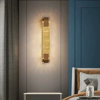 Art deco gilded sconce installed in boutique bedroom
