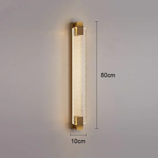 Gold art deco wall sconce installed in hotel lobby