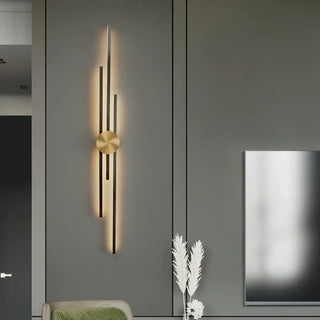 Gold 3-bar wall sconce installed in contemporary living room