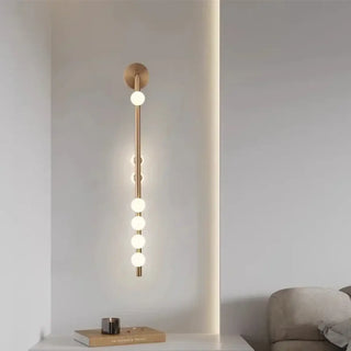 Slender brass wall sconce with frosted glass globe – gold IP20