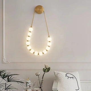 SUITY gold LED wall sconce with white globe balls