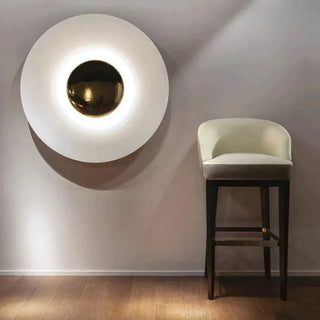 Blue round eclipse wall sconce installed in hallway