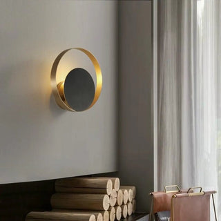 Round black gold sconce installed – modern living room accent