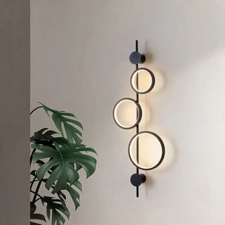 Three LED circles wall sconce installed view modern