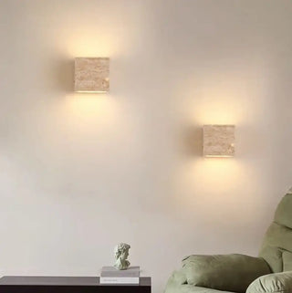 Square travertine stone sconce close-up texture
