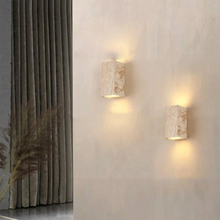 Square travertine wall sconce installed – warm mineral glow