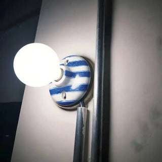 White and blue striped glass wall light – close-up