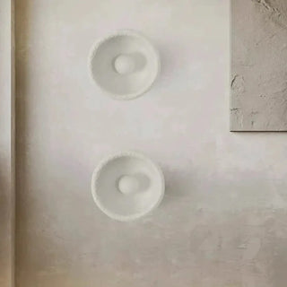 White resin wall sconce close-up – 3000K warm ceramic round design