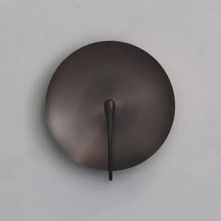 Metal disc wall sconce close-up LED warm glow