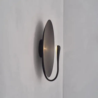 Black metal disc wall light installed view interior
