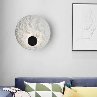 White eclipse wall sconce installed in contemporary living room