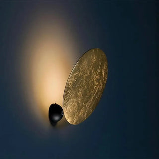 Moon effect wall sconce close-up gold metal texture