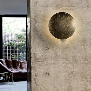 Moon wall sconce 3kg gold – installed in boutique interior