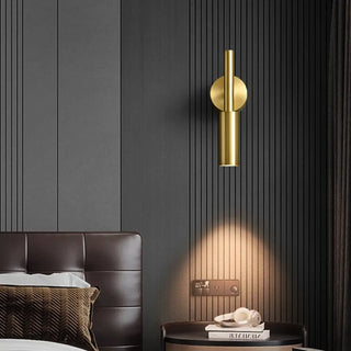Gold art deco wall lamp close-up – aluminum tube and round support detail