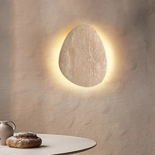 Travertine stone wall light close-up – beige organic 19×25×12cm