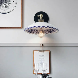 Vintage white ceramic wall sconce with blue floral pattern – front
