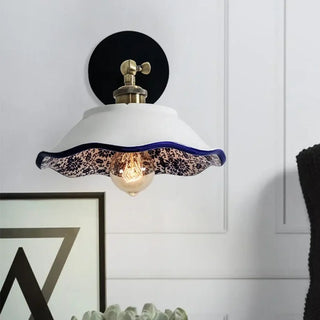 White ceramic E27 wall sconce variant C installed in bedroom