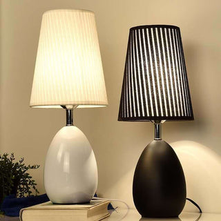 Monochrome table lamp close-up — fabric touch detail