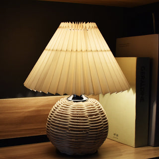 Bamboo woven table lamp illuminated — pleated shade cozy glow