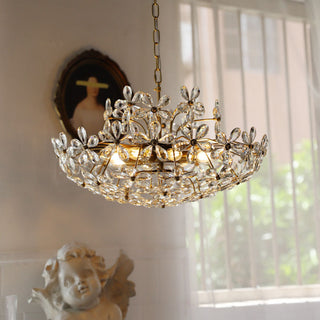 Modern crystal chandelier detail — brass bouquet luxury dining warm