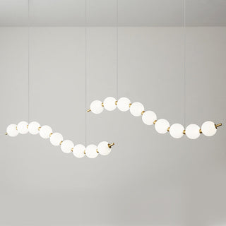 Modern chandelier with white ball pendants and brass