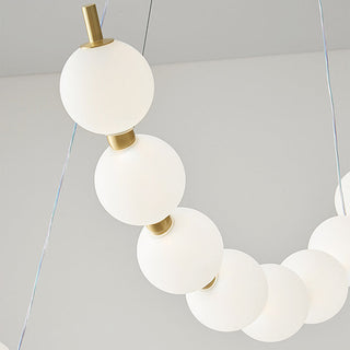 Pearl LED ball chandelier side — modern brass acrylic warm glow