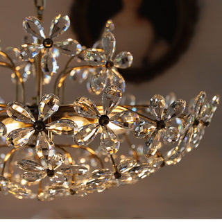 Modern crystal brass chandelier ambient — bouquet luxury warm glow