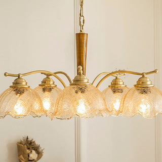 Mid-century copper chandelier illuminated — glass petal warm ambient