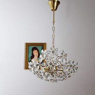 Crystal brass chandelier close-up — luxury bouquet dining detail