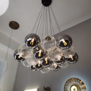 Glass bubble LED chandelier setting — modern ball dining wide