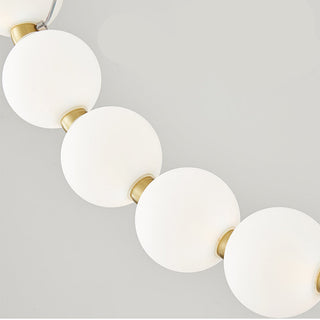 White ball LED chandelier close-up — pearl brass acrylic detail