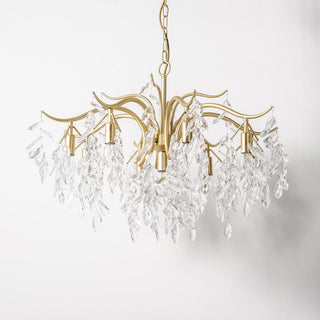 Large gold crystal chandelier detail — tiered modern dining warm