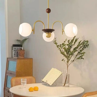 Contemporary ribbed glass chandelier detail — cream dining warm