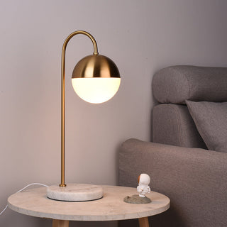 Sphere lamp brass arc — radiant orb close-up elegant detail