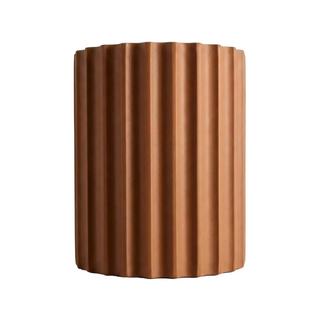 A cylindrical object with a textured surface, resembling a piece of pottery or a ceramic item.