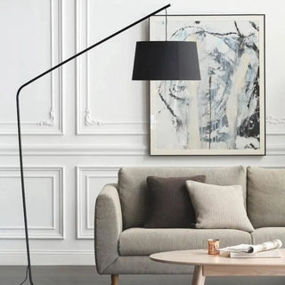 GRANV large arc floor lamp – angled view over sofa