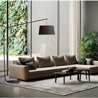 GRANV large arc floor lamp – neutral tones over sectional sofa