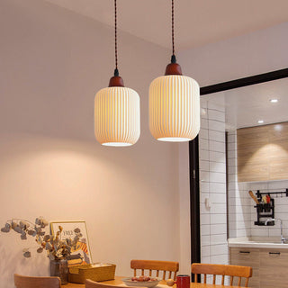 White ceramic pendant casting warm Nordic glow