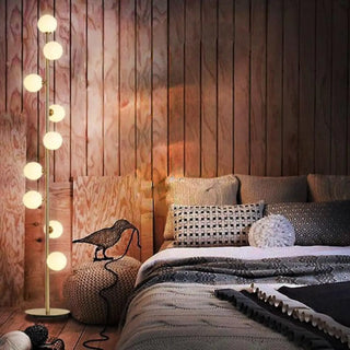 BALL golden floor lamp – lit in living room
