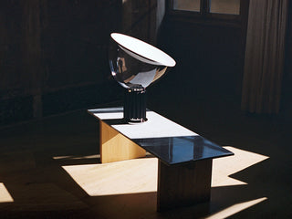 Minimalist black desk lamp illuminated — gloss white glow