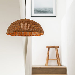 Round rattan pendant over dining table — natural bamboo weave