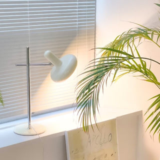 Modern glass disc lamp illuminated — iron base warm ambient