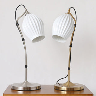 Vintage ceramic table lamp illuminated — white ribbed warm